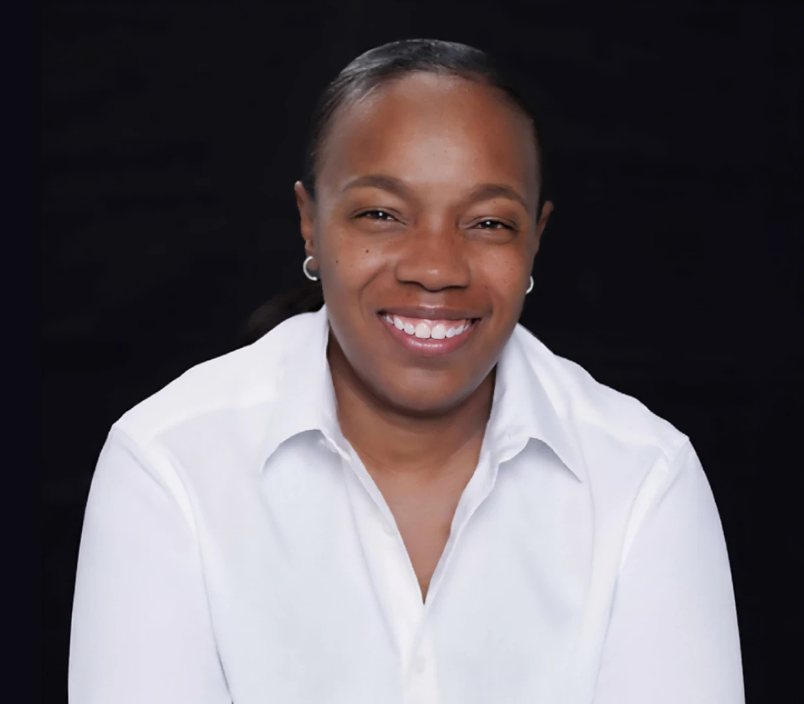 Smiling person in a white shirt.